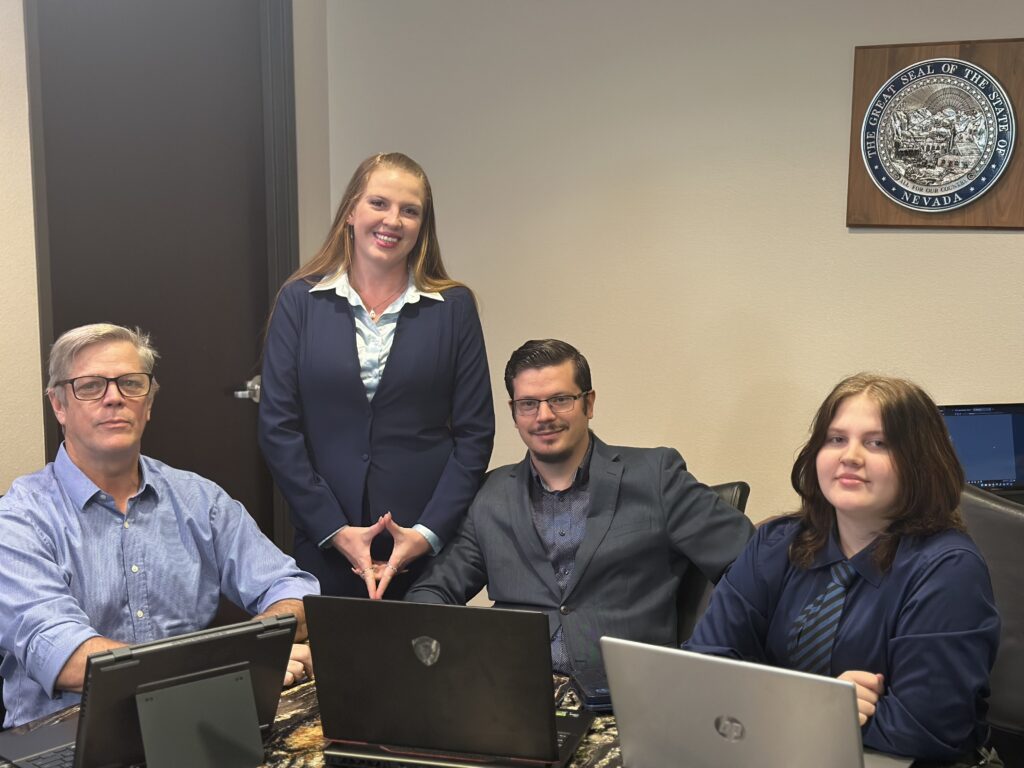 Synergy Solution IT team members including three generations of the Synergy family posing together in a Las Vegas office, representing trusted local IT support